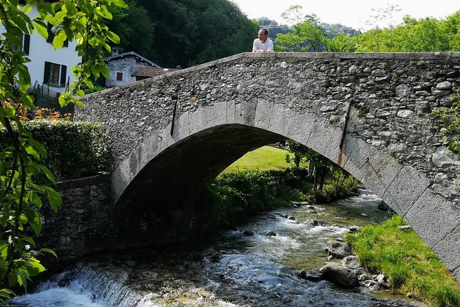 E-Bike Tour around Three Lakes and Idyllic Mountain Life - Velzo climbing: grape vines, mountain views, and tight village navigation